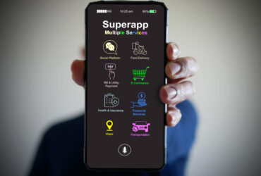 Hand holds a smartphone with a super app for mobile phones that serves multiple services as a one-stop service.